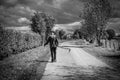 Bullingen, Walloon Regio - East Belgium - An old farmer carrying a scythe, looking like the Grim Reaper