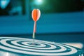 Bulls eye or dart board has red dart arrow throw hitting the center of a shooting target Royalty Free Stock Photo