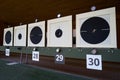 Bullseye target with bullet holes in center, close-up. Gun shooting range Royalty Free Stock Photo