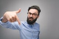 Bully man in glasses gesturing at camera