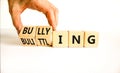 Bullying and belittling symbol. Concept words Bullying and Belittling on wooden cubes. Businessman hand. Beautiful white table Royalty Free Stock Photo