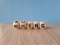 Bullying and belittling symbol. Concept words Bullying and Belittling on wooden cubes. Beautiful wooden table, blue background. Royalty Free Stock Photo