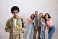 Bullying and racism, problems in college. Sad african american smart guy with glasses holds books