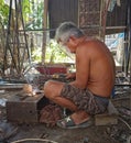 Bulukumba, IAn old man is welding iron and wearing eye protection Royalty Free Stock Photo