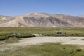 Bulunkul, Tajikistan, August 23 2018: Women in Bulunkul have laid Laundry for drying in the meadow