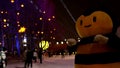 Bumble bee skating in public ice rink with many people outdoor, winter sport activity