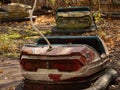 Bumper car in abandoned amusement park in Pripyat, Chernobyl Exclusion Zone in autumn. Ukraine. Royalty Free Stock Photo