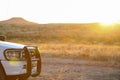 Bumper from 4x4 SUV with mountain and sunset in the background,