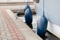 Bumpers hung at the side of the yacht. Moored and secured boats Royalty Free Stock Photo