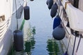 Bumpers protection between two moored boats in a small harbour Royalty Free Stock Photo