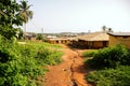 Bumpy and eroded road leading to village school in Africa Royalty Free Stock Photo