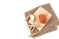 Bun on a cutting board on canvas napkin, ears of wheat and cloves of garlic on white background flat lay Royalty Free Stock Photo