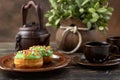 Bun, donut covered with glaze. Tutti frutti bun on a plate. Sweet pastries. Dessert. Still life. Close-up Royalty Free Stock Photo