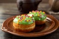 Bun, donut covered with glaze. Tutti frutti bun on a plate. Sweet pastries. Dessert. Still life. Close-up Royalty Free Stock Photo