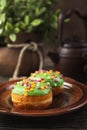 Bun, donut covered with glaze. Tutti frutti bun on a plate. Sweet pastries. Dessert. Still life. Close-up. Royalty Free Stock Photo