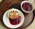 Bun in the form of the boy and raspberry jam.