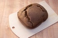 A bun of fresh black Borodino bread baked in a bread machine. Aromatic homemade cakes