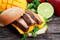 Bun with grilled roast beef, mango and arugula. Royalty Free Stock Photo