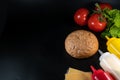 Bun, hamburger bread and burger ingredients. Sauce, Cheese, Salad and Vegetables. Concept for the production of fast food bread. Royalty Free Stock Photo