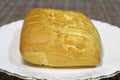 Bun on a plate on the table. Royalty Free Stock Photo