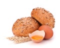 Bun with seeds and broken egg Royalty Free Stock Photo