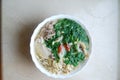 Bun Thang - traditional vietnamese dish with shredded chicken, ham and eggs which is garnished by chopped cilantro.