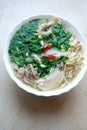 Bun Thang - traditional vietnamese dish with shredded chicken, ham and eggs which is garnished by chopped cilantro.