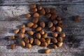 Bunch of almonds unshelled, badam, forest fruit harvest on wood Royalty Free Stock Photo