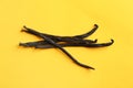 Bunch of aromatic vanilla sticks on yellow Royalty Free Stock Photo