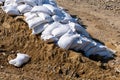 A bunch of bags with cement, sand outside. Material for building construction. Building. Royalty Free Stock Photo