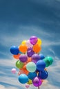 Bunch of balloons aloft against a cloudy sky Royalty Free Stock Photo