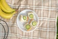 A Bunch of bananas ,badminton rackets and small summer sandwiches for summer family sport picnic, top view. Royalty Free Stock Photo