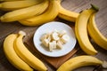 Bunch of bananas - banana sliced on wooden background, ripe banana peel fruit on floor Royalty Free Stock Photo