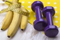 Bunch of bananas, measurement tape and dumbbells