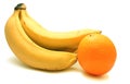 Bunch of bananas and one orange Royalty Free Stock Photo