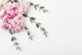 Bunch of beautiful flowers and eucalyptus leaves on white table top view. Flat lay style.