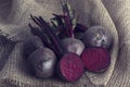 Bunch of beetroot on a brown burlap cloth in artistic conversion