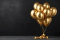 Bunch of big golden balloons objects for birthday party isolated on a black background Royalty Free Stock Photo