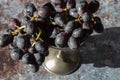 Bunch of black grapes in an old pewter goblet.