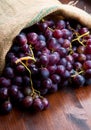Bunch black grapes on wooden background Royalty Free Stock Photo