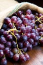 Bunch black grapes on wooden background Royalty Free Stock Photo