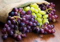 Bunch black and green grapes on wooden Royalty Free Stock Photo