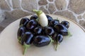 A bunch of black and white eggplants are on a table Royalty Free Stock Photo