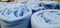 A bunch of blue blankets folded in rolls Royalty Free Stock Photo