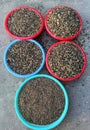 A bunch of bowls filled with different kinds of stones. gravel and scree ground.