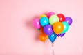 Bunch of bright balloons on color background