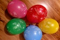 Bunch of bright balloons party. Colorful carnival or party background of balloons, streamers and confetti on wooden parquet Royalty Free Stock Photo