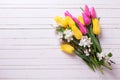 Bunch of bright yellow and pink spring tulips and apple tree flo Royalty Free Stock Photo