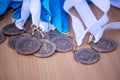 A bunch of bronze medals on a white and blue ribbon for third place in sports competitions