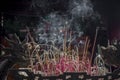 Bunch of burning incense sticks with smoke trails vietnam